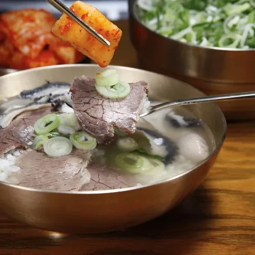 河东馆汤饭配图，能看到牛肉、葱与萝卜泡菜的搭配；已核对原页截图。
